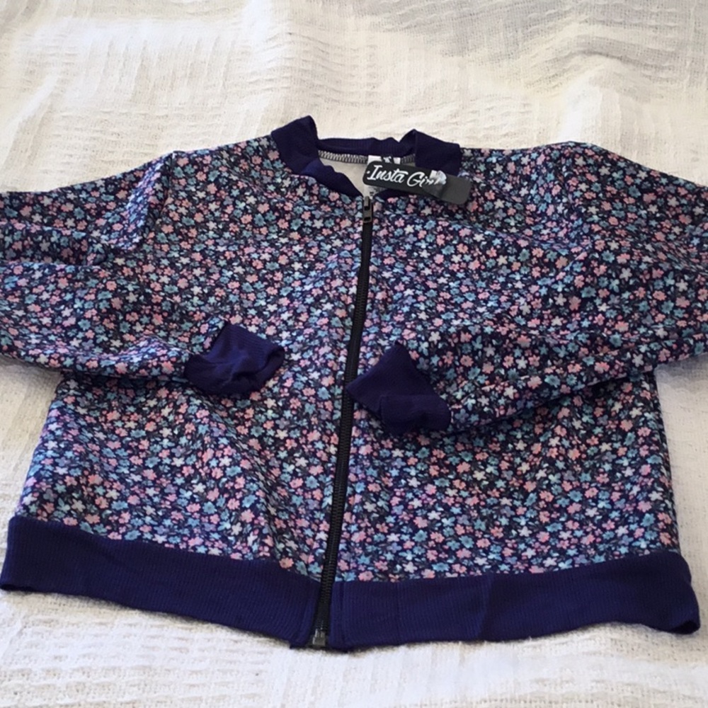 Girls NWT light jacket. Size M10-12. Floral design